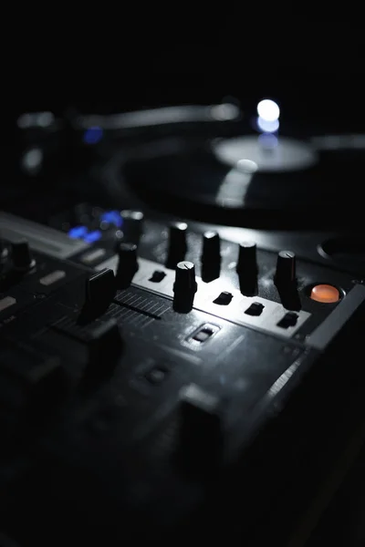 DJ sound mixer and vinyl turntable in night club. Professional disc jockey setup on stage