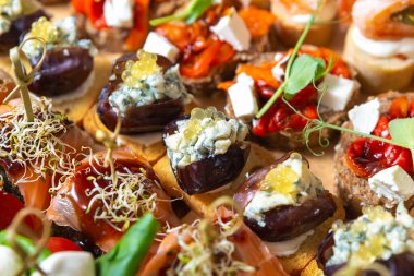 Gourmet snack food for wine party. Many different delicious canape snacks with seafood and exotic ingredients. 
