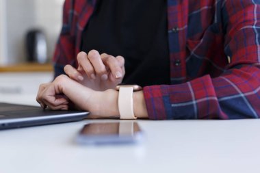 Young girl using smart watch gadget. Close up photo of female person browsing notifications on modern smart wrist watches