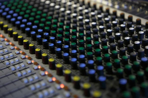 Professional audio mixer panel with volume regulators and faders. Sound mixing console on concert stage