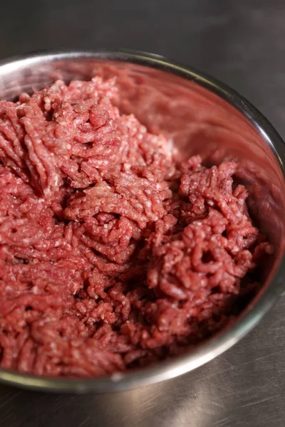 Minced ground beef meat in a stewpan. Natural red cow fillet prepared for cooking in a commercial kitchen