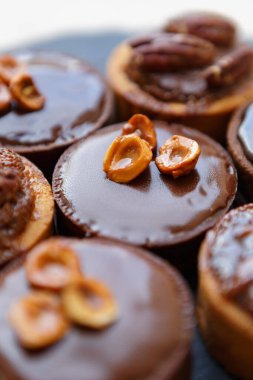 Koyu çikolata ve fındıkla süslenmiş lezzetli kurabiyeler. Öğle yemeği için hamur kafeteryasında pişmiş lezzetli tatlılar.