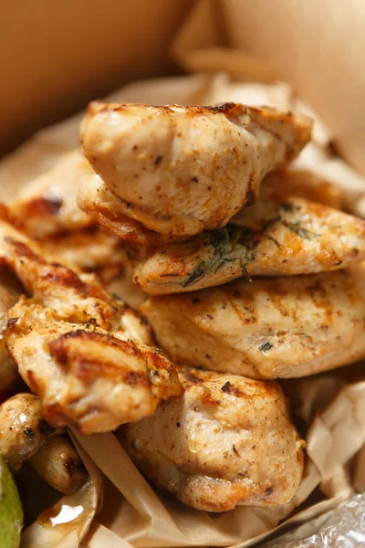 Delicious chicken meat cooked on grill and delivered in a box for business lunch meal