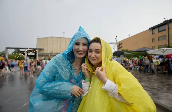 快乐的男女同性恋 双性恋和变性者夫妇穿着雨衣共度暑假 两个快乐的 多样化的女人在外面的雨中享受公共活动的乐趣 — 图库照片