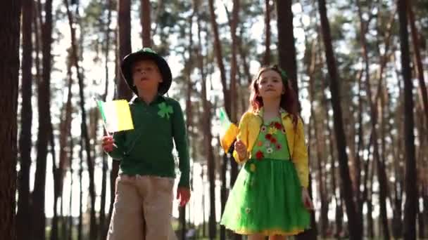 Couple Kids Dressed Patricks Day Celebration Walking Sunny Forest Flags — Stockvideo