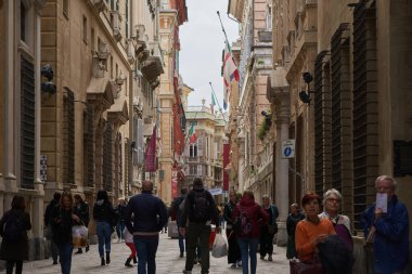 Genova 'nın hisorik merkezindeki Via Garibaldi caddesinde büyük bir grup turist yürüyor. GENOA - 1 Mayıs 2019