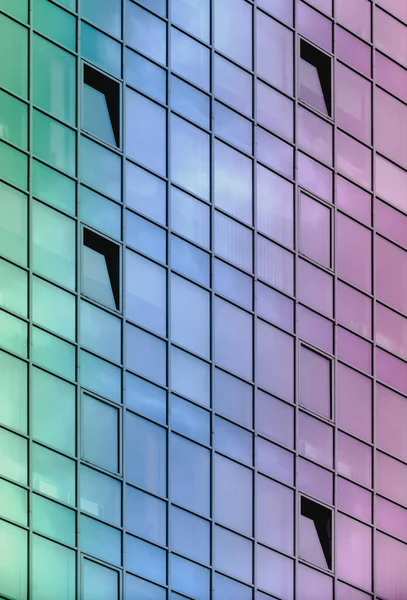 Glass building facade painted with pastel-saturated color gradient