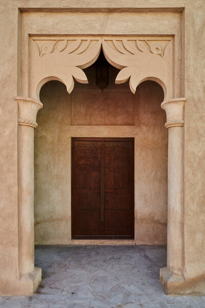 Front door and arch in old Arab house in Al Fahidi neighborhood, historic landmark in East Dubai