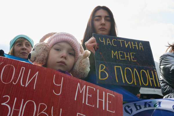 Ukrainian family demonstrating banners dedicated to captured soldiers on a peaceful demonstration. Kyiv - 3 March, 2024
