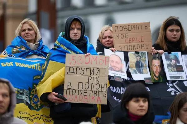 Kayıp ve yakalanan Ukraynalı askerlerin aileleri, 25 Şubat 2024 'te Kyiv' de düzenlenen bir gösteride pankartlarla poz verdiler.