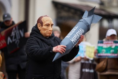 Actor plays vladimir putin who is going to destroy the Drama Theatre in Mariupol during the art performance dedicated to the anniversary of tragedy. Kyiv - 17 March,2024 clipart