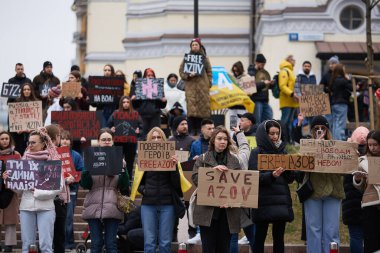 Mariupol ve Azovstal 'in tutuklu savunucularına adanmış bir gösteride ellerinde posterler ve bayraklarla poz veren bir grup Ukraynalı aktivist. Kyiv - 17 Mart 2024