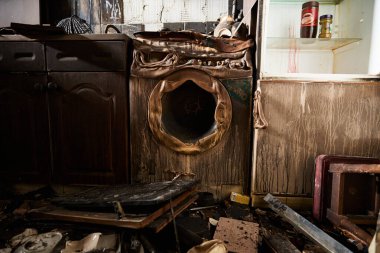 Remains of a washing machine in the burnt Ukrainian house after massive russian air attack on civil infrastructure in Kyiv - 23 March,2024 clipart