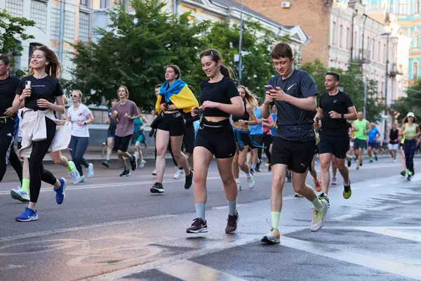 stock image Large crowd of active and healthy people runs a marathon in urban setting in Kyiv - 1 June,2024