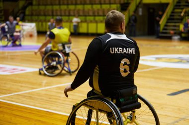 Sahada tekerlekli sandalyede uyumlu basketbol koçu. Kyiv - 12 Aralık 2023