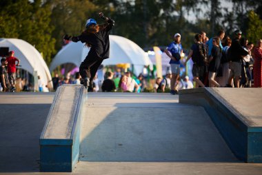 Roller blader girl performing soul grind trick on a ledge in skatepark. Kyiv - 4 August,2024 clipart