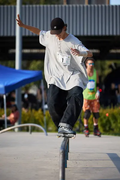 stock image Roller doing acid soul grind on rail in a skate park in summer. Kyiv - 4 August,2024