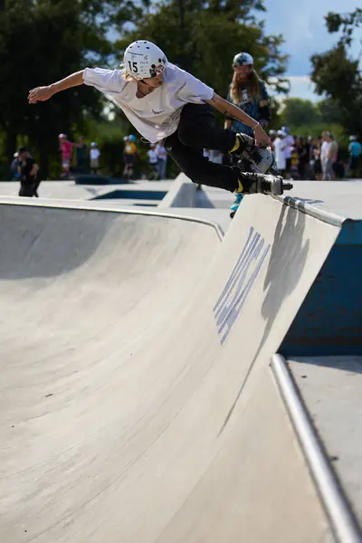 stock image In-line roller performing fishbrain grind in a skate pool. Kyiv - 4 August,2024