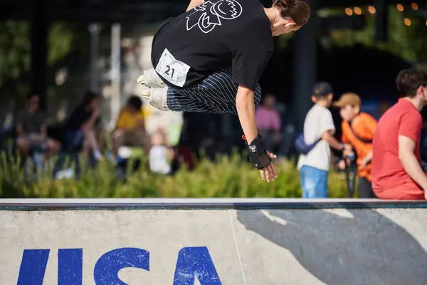 stock image Roller jumping on a radius ramp in a skatepark. In-line skate skating on aggressive skates. Kyiv - 4 August,2024