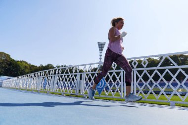 Woman running outdoors in summer. Kyiv - 10 August,2024 clipart