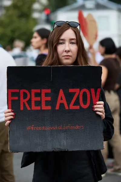 stock image Young woman demonstrating with a sign 