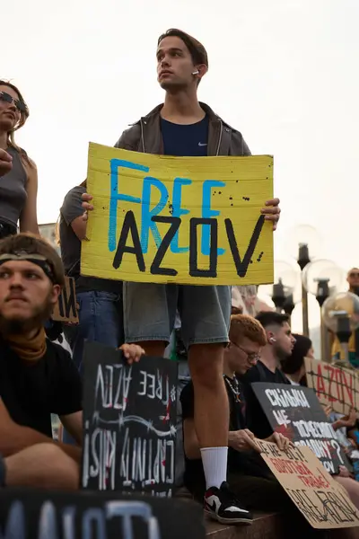 stock image Young Ukrainian guy demonstrating with a sign Free Azov in Kyiv - 15 September,2024