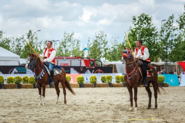 Horseback javelin throwers at Etnospor Kultur Festivali. Istanbul - 11 May,2018 clipart