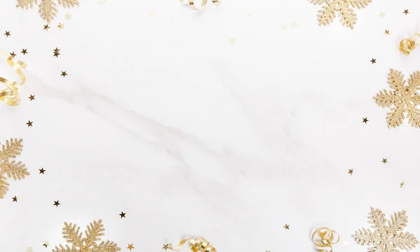 stock image Christmas decorations in gold colors on marble background with empty copy space for text. Gift, holiday and celebration concept, top view, flat lay