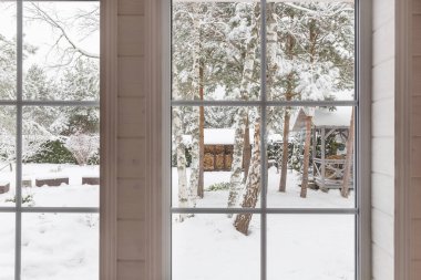Home vinyl insulated windows with winter view of snowy trees and plants, courtyard clipart