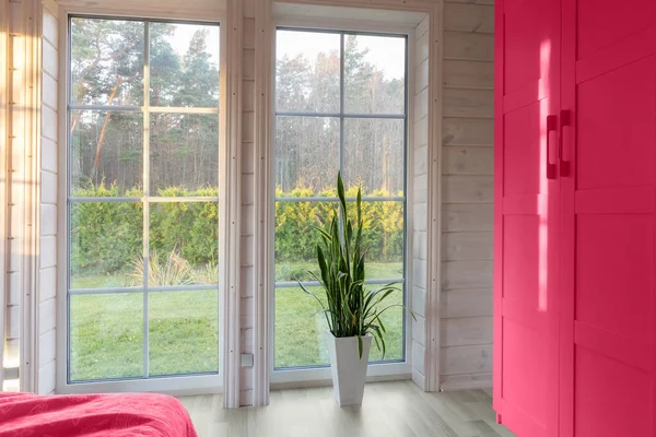 Bright photo studio interior with big window. Viva magenta - trendy color of year 2023 in interior. Scandinavian style