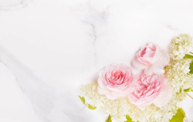 Festive pink flower rose composition on marblebackground. Overhead top view, flat lay. Copy space. Birthday, Mothers, Valentines, Womens, Wedding Day concept.