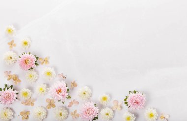 Spring frame of small flowers and daisy, floral arrangement on marble backgraund