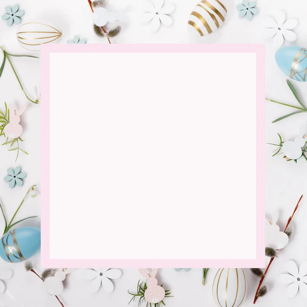 Festive Easter border, frame from easter eggs and spring flower crocus on blue background. Stylish easter flat lay blue