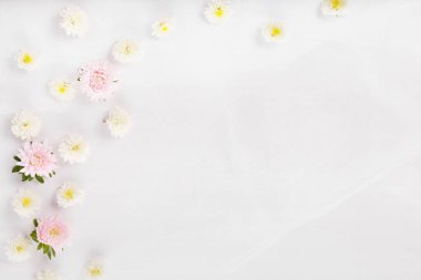 Spring frame of small flowers and daisy, floral arrangement on marble backgraund