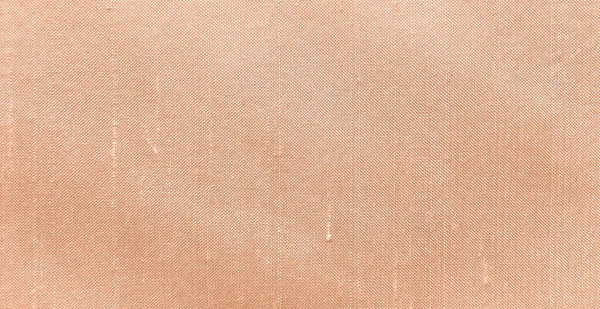 Fabric swatch close up of trend color of the year 2024 peach fuzz background swatch