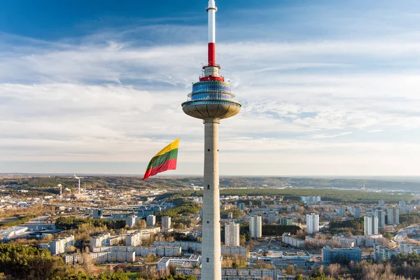 stock image VILNIUS, LITHUANIA - FEBRUARY 16, 2022: Giant tricolor Lithuanian flag waving on Vilnius television tower on the celebration of Restoration of the State Day in Vilnius.