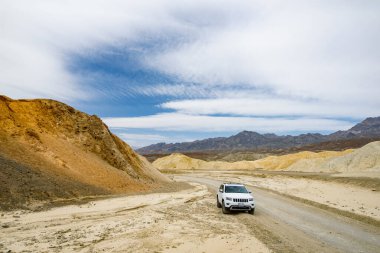 DEATH VALLEY, CALIFORNIA, USA - APRIL 2016: Jeep Grand Cherokee on famous Twenty Mule Teams road in Death Valley National Park, California, USA. Exploring the American Southwest.