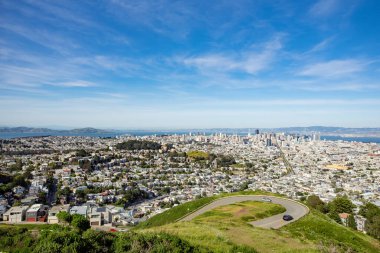 Curvy road and view of downtown from Twin Peaks, in San Francisco, California, USA