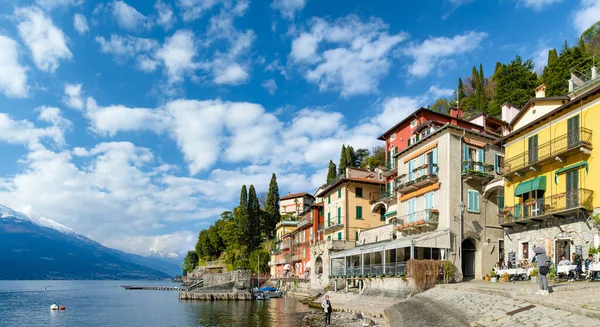 stock image VARENNA, ITALY - APRIL 2022: Tourists and locals spending sunny spring day in Varenna, a town on the shore of Lake Como. Charming location with typical Italian atmosphere. Varenna, Lombardy, Italy.