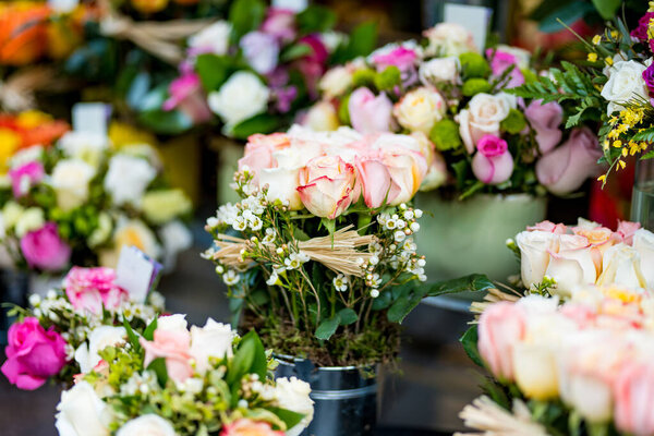 Beautiful colorful rose bouquets sold on outdoor flower shop in Milan, Italy
