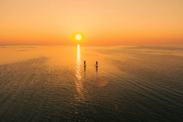 Aerial View Two People Stand Paddle Boards Quiet Sea Sunset — Stock Photo, Image