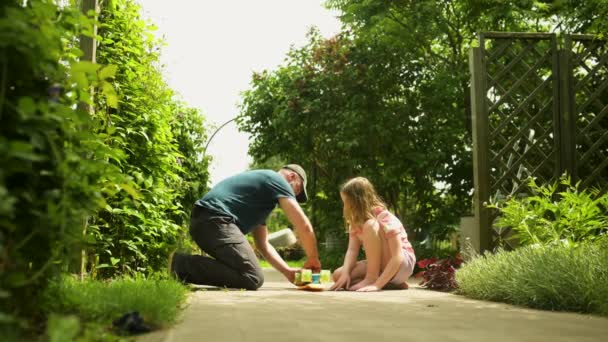 Young Father Fixing Skateboard His Young Daughter Pretty Little Girl — Stock video