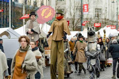 VILNIUS, LITHUANIA - 4 Mart 2023: Kaziuko muge veya Kaziukas, geleneksel Paskalya pazarı sırasında mizahi geçit törenine katılan neşeli insanlar, her Mart ayında Old Town sokaklarında el sanatları fuarı düzenleniyor.