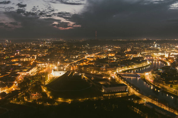 Scenic aerial view of Vilnius Old Town and Neris river at nightfall. Sunset landscape. Night view of Vilnius, Lithuania.