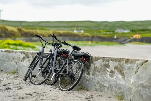 stock image Two electric bikes parked on Inishmore, the largest of the Aran Islands in Galway Bay, Ireland. Renting a bicycle is one of the most popular way to get around Inis Mor.