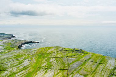 Inishmore veya Inis Mor, Galway Bay, İrlanda Aran Adaları en büyük havadan görünümü. Güçlü İrlanda kültürü, İrlanda diline sadakati ve antik kentlerin zenginliği ile ünlüdür..