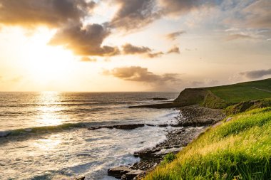 Mullaghmore Head 'in muhteşem gün batımı manzarası. Büyük dalgalar kıyıya vuruyor. Akşam ışığında kayalık kıyı şeridi olan resim gibi bir manzara. Vahşi Atlantik Yolu 'nun imza noktası, Sligo İlçesi, İrlanda