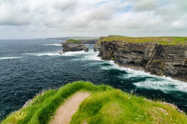 Spectacular Kilkee Cliffs, situated at the Loop Head Peninsula, remote and wild stretch of stunning coastline, Wild Atlantic Way Discovery Point, county Clare, Ireland. clipart