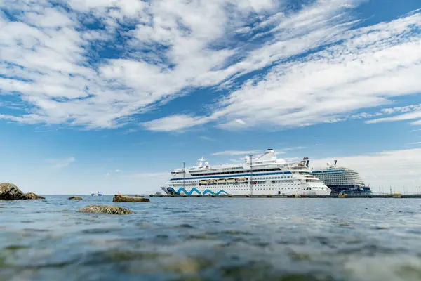 stock image TALLINN, ESTONIA - AUGUST 12, 2023: Cruise ships docked in port of Tallinn. Cruise ship Avitak, formerly AidaVita, ready for new sea adventure.