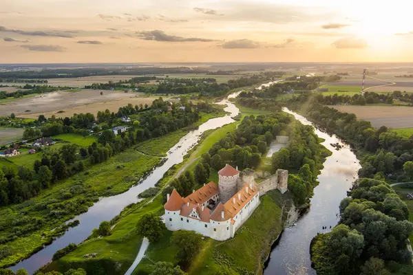 stock image Aerial view of Bauska Castle or Bauskas pils. Ruins of Livonian Order Castle and a later palace, residence of the Duke of Courland and home to the Castle Museum today. Sunny summer evening landscape.